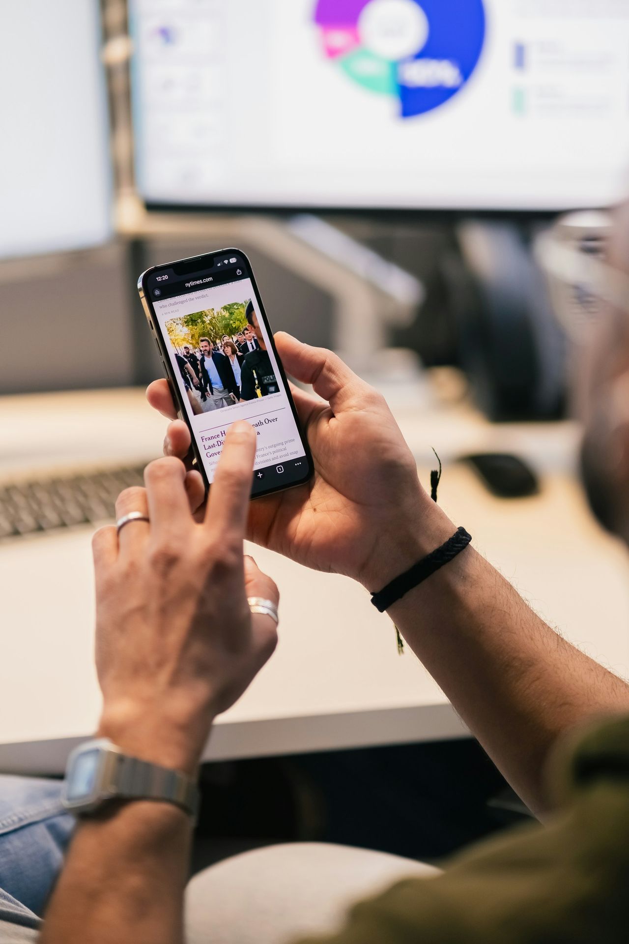Person using smartphone with news article displayed